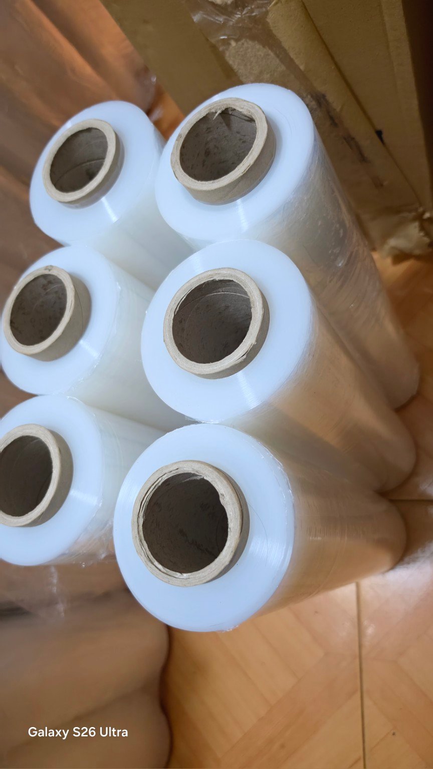 Top angled view of clear stretch film rolls showing their cardboard cores