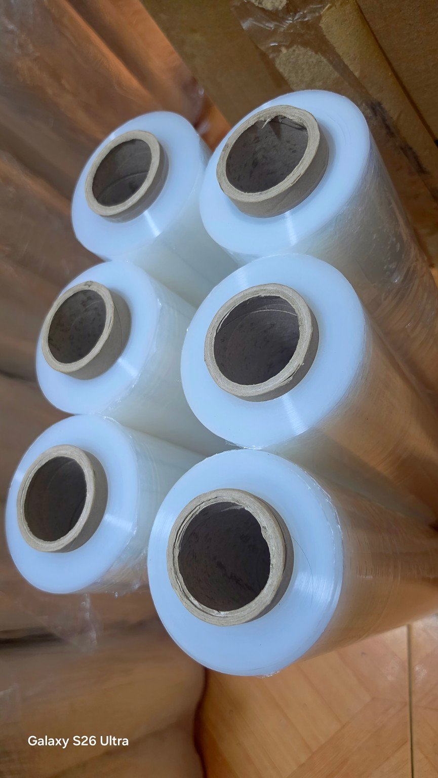 Close-up top view of clear stretch film rolls and cardboard cores