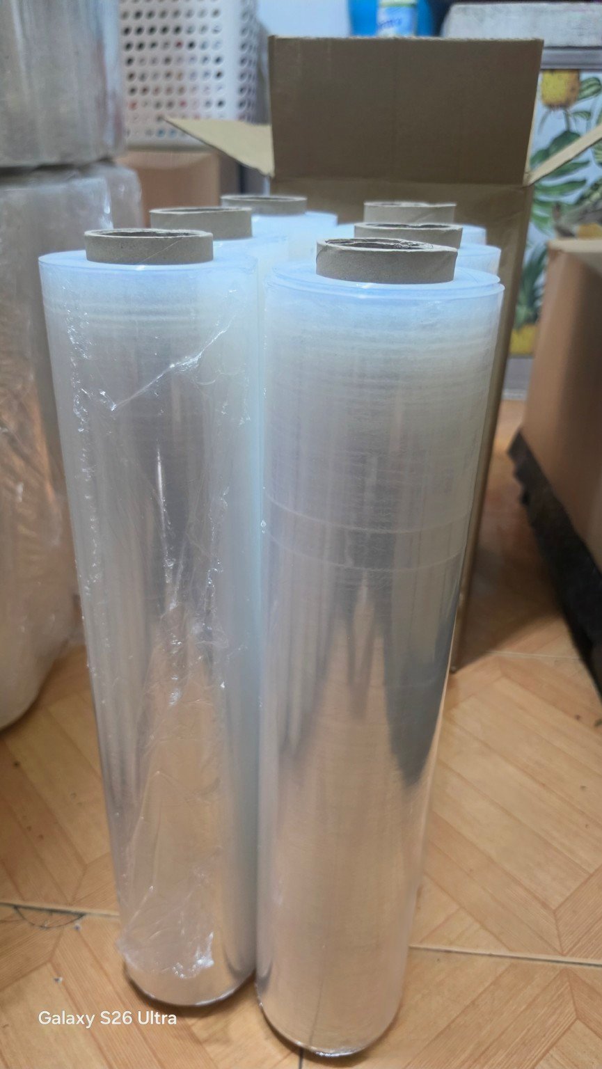Close-up of upright clear stretch film rolls showing the transparent film